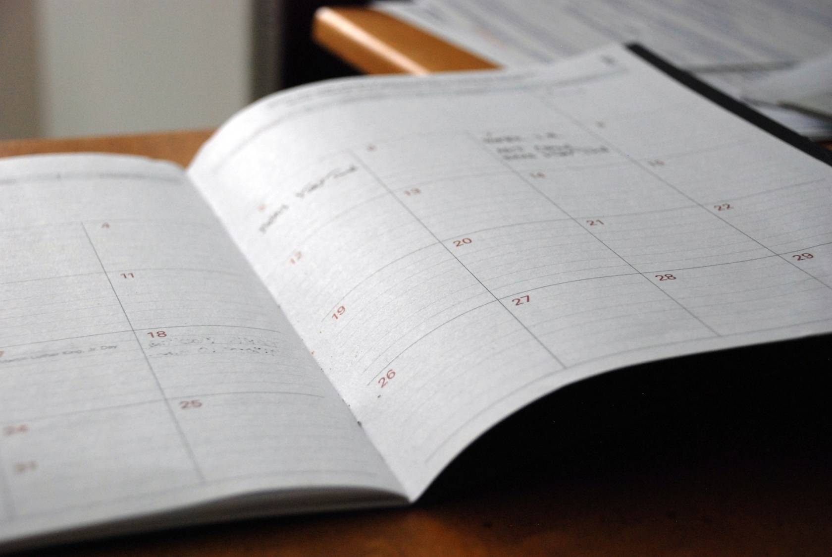 Paper with text section for each day of the week in a notebook for creating an Instagram content calendar.